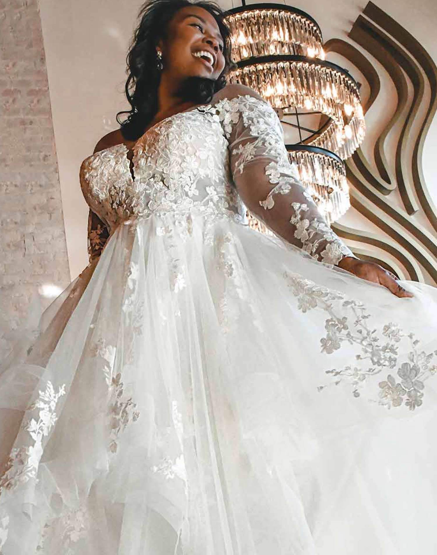 Model wearing a white gown. Mobile image