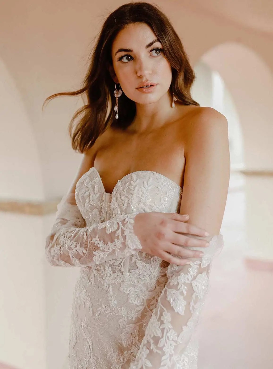 Model wearing a white gown by Martina Liana
