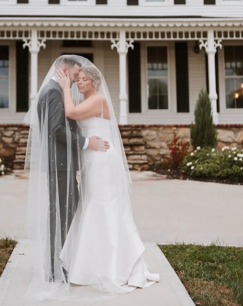 Сouple wearing a white gown and a gray suit