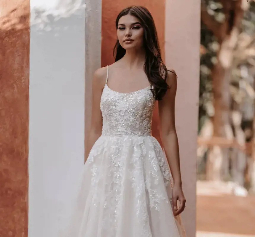 Model wearing a white gown by Allure Bridals