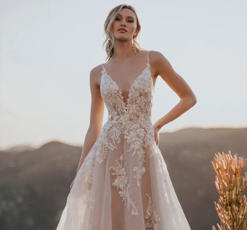 Model wearing a white gown by Allure Bridals