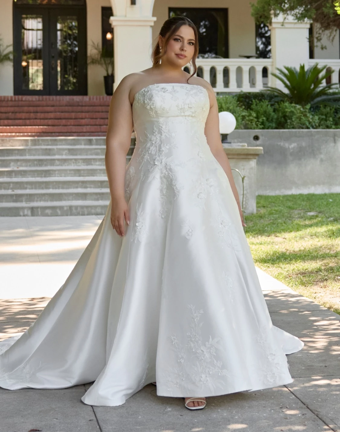 Model wearing a white gown. Mobile image