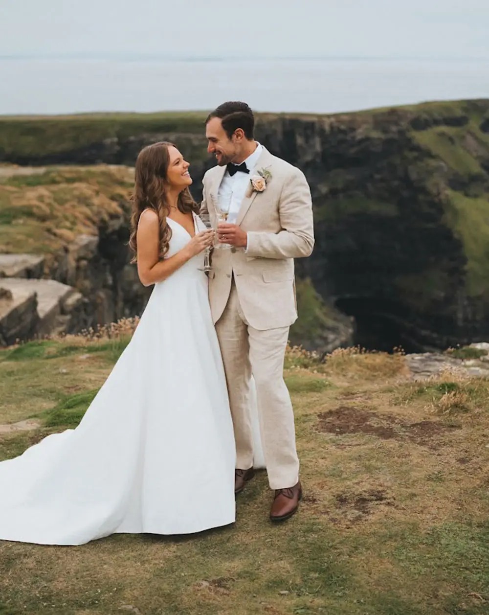 Сouple wearing a white gown and a gray suit