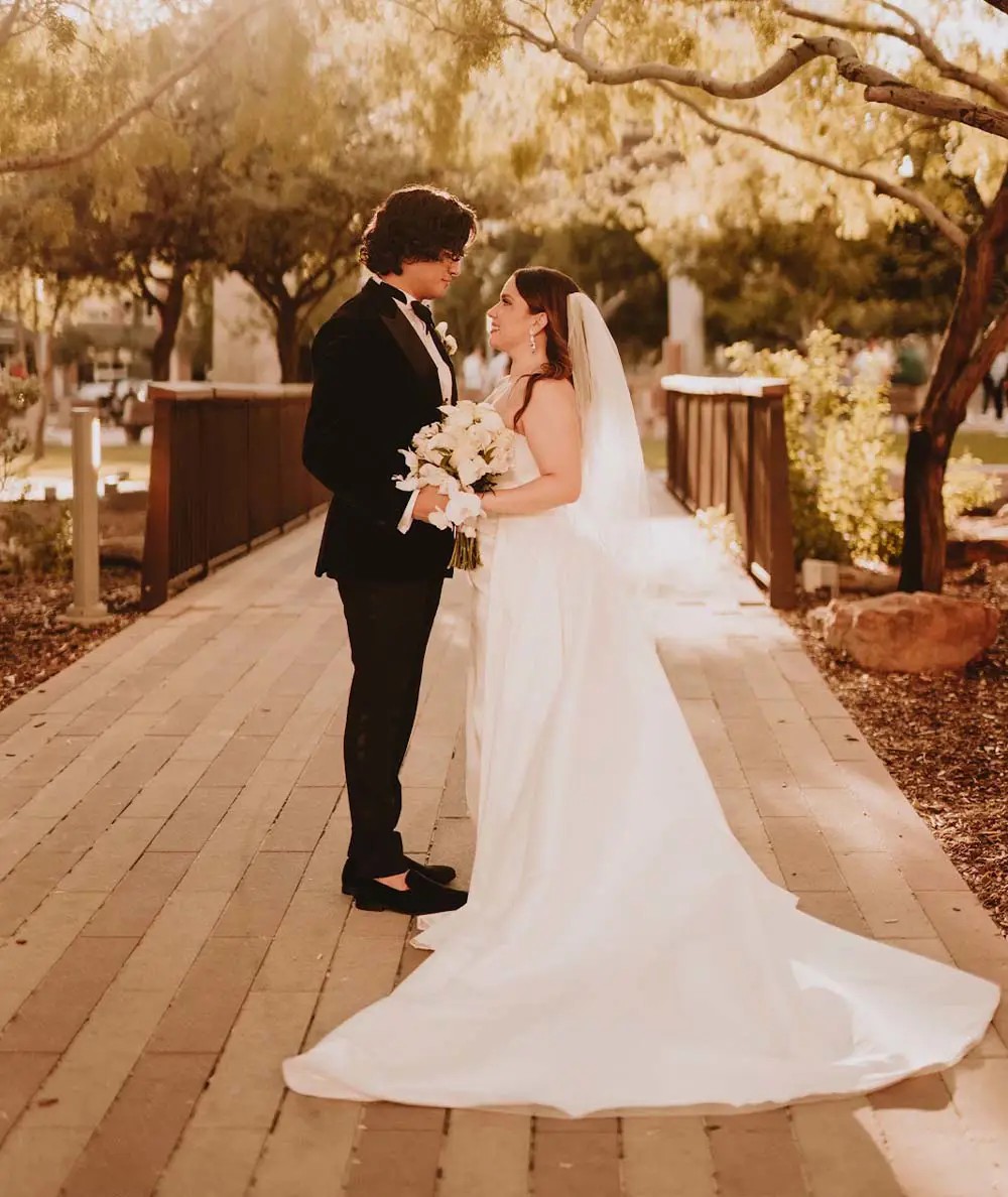 Сouple wearing a white gown and a brown suit