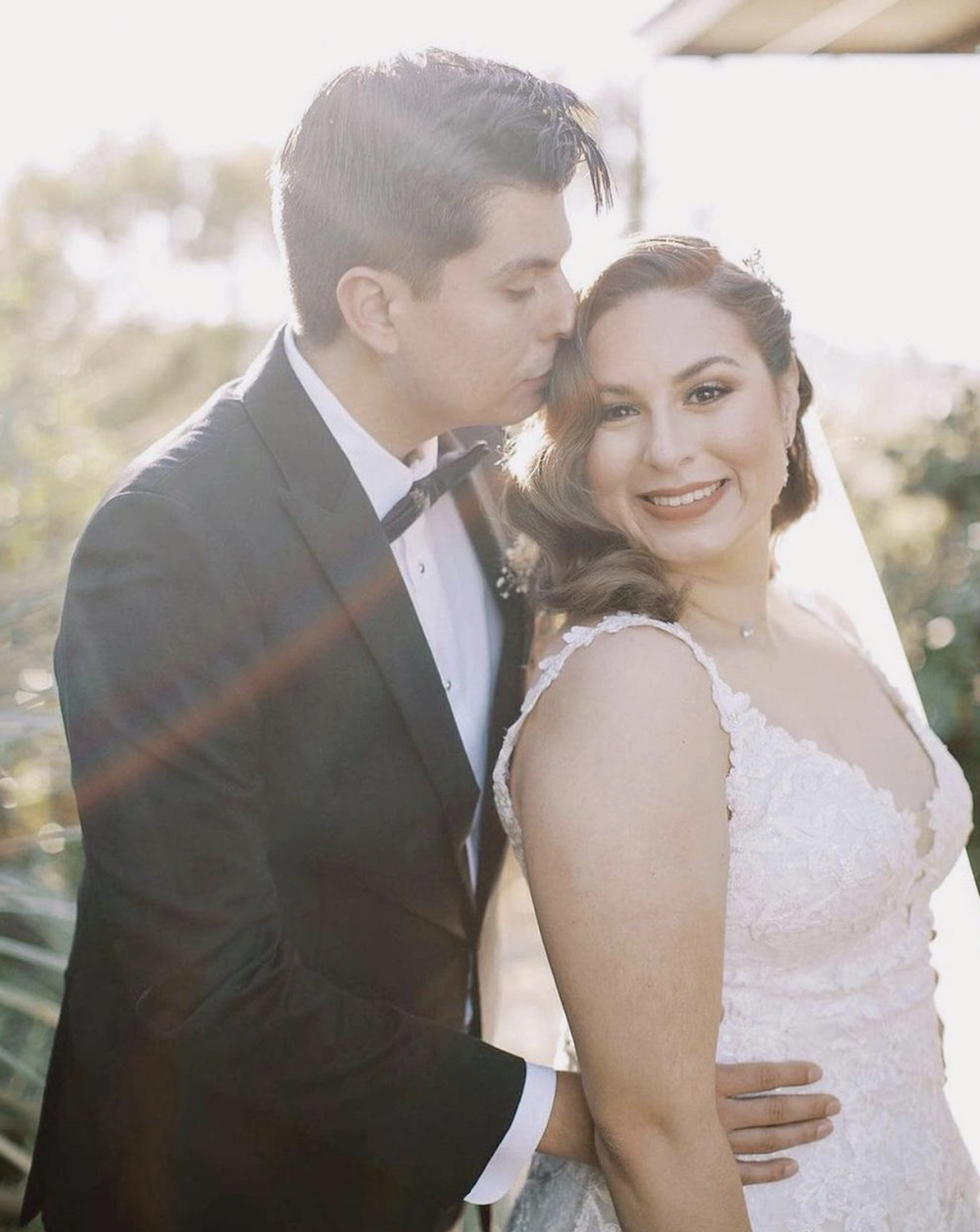 Сouple wearing a white gown and a gray suit