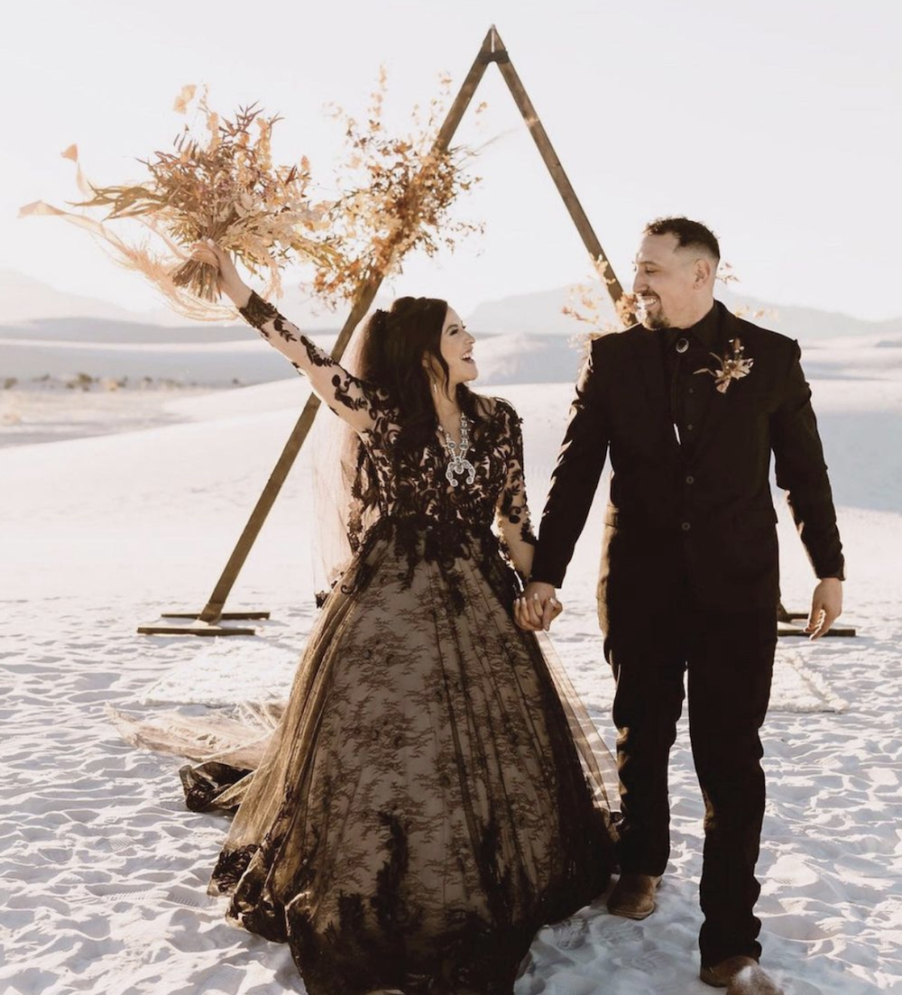 Сouple wearing a white gown and a black suit