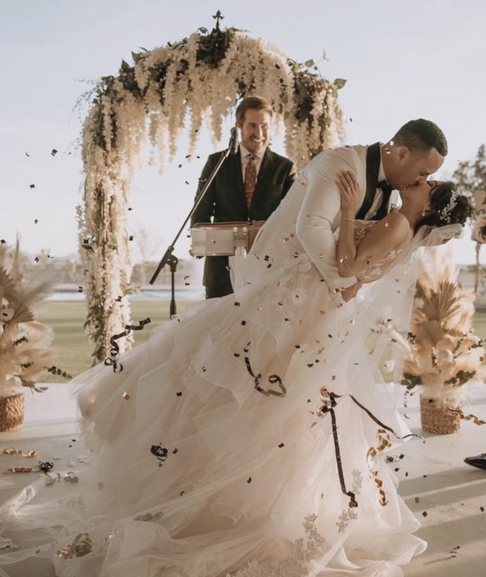 Сouple wearing a white gown and a brown suit